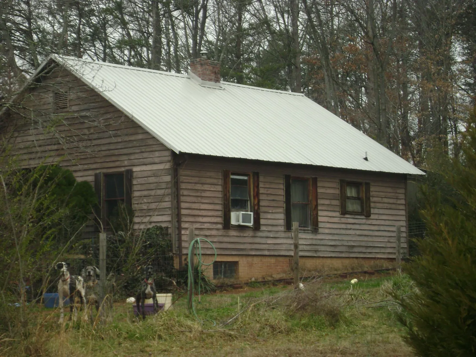 White metal roof on an old wood sided farmhouse, from a Metal Roof Installation job in Commerce
